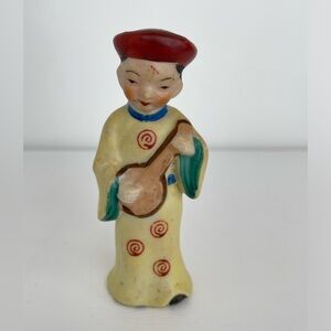 Vintage Asian figurine, woman with red hat and instrument, yellow dress
